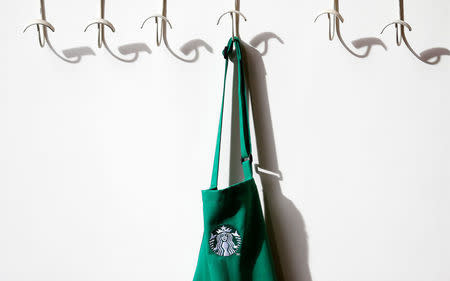 A barrista's apron hangs on a peg in Starbucks' Mayfair Vigo Street branch in central London September 12, 2012. REUTERS/Andrew Winning/File Photo