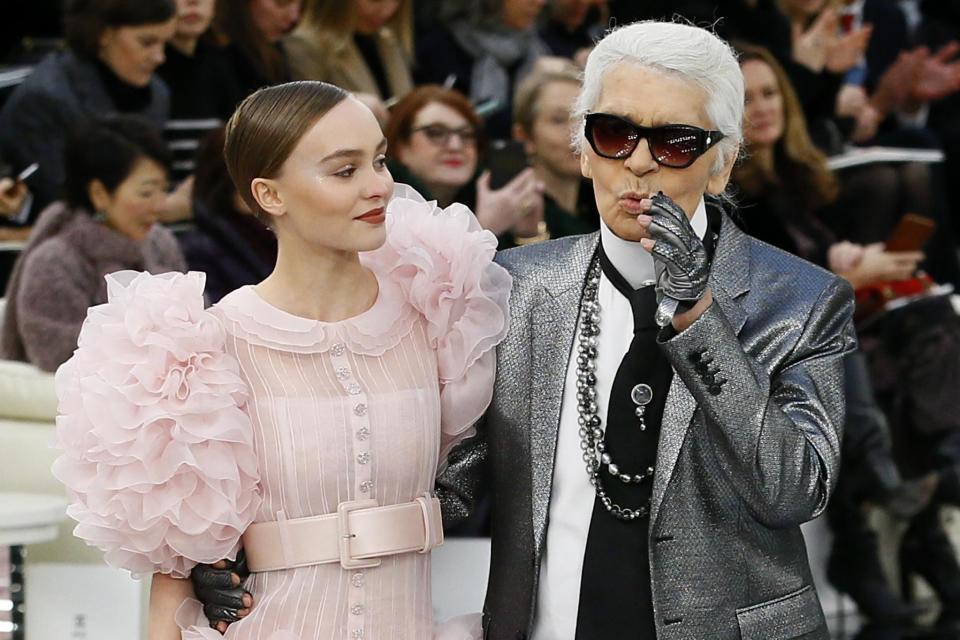 Lily-Rose Depp models with German fashion designer Karl Lagerfeld during Chanel's Haute Couture Spring-Summer 2017 fashion collection prsented in Paris, Tuesday, Jan.24, 2017. (AP Photo/Francois Mori)