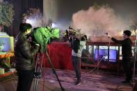 A cameraman films a puppet-master in action during a filming session of the Pili puppet show, that started in the '80s, in Yunlin, Taiwan