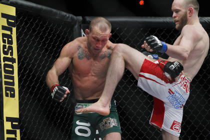 TJ Grant knees Gray Maynard during their fight. (USA Today)