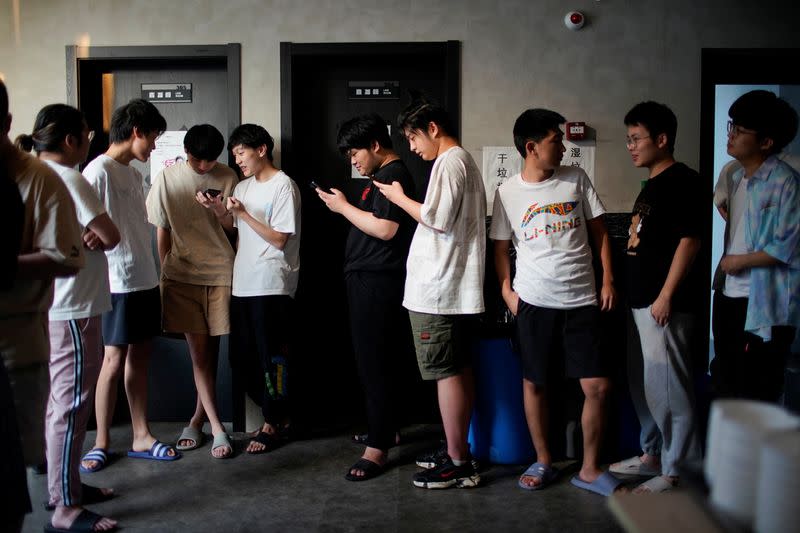 Players of Rogue Warriors esports team take a break before their dinner, in a cafeteria at their club in Shanghai