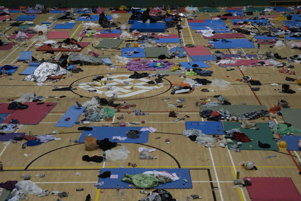 Protesters rest in a gymnasium on the campus of the Polytechnic University in Hong Kong on Wednesday, Nov. 20, 2019. A small group of protesters refused to leave Hong Kong Polytechnic University, the remnants of hundreds who took over the campus for several days. They won't leave because they would face arrest. Police have set up a cordon around the area to prevent anyone from escaping. (AP Photo/Ng Han Guan)