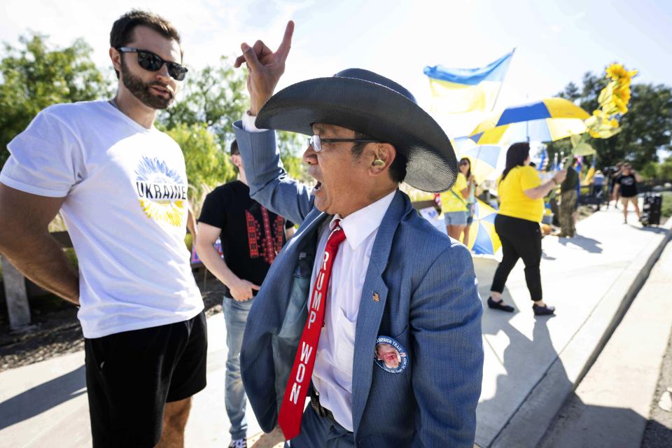 A Trump supporter says America first to Ukranian supporters before the second Republican presidential debate at the Ronald Reagan Presidential Library in Simi Valley, Calif., on Wednesday, Sept. 27, 2023. | Sarah Reingewirtz, The Orange County Register via AP