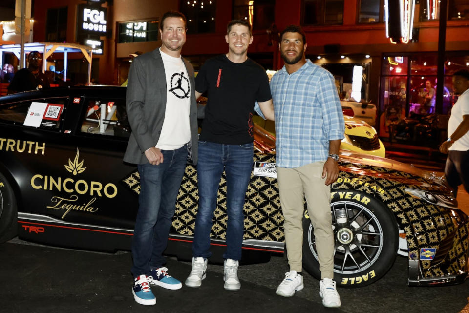 <p>Kurt Busch, Denny Hamlin and Bubba Wallace come together in front of Cincoro's show car at Layer Cake in Nashville to celebrate NASCAR race weekend.</p>