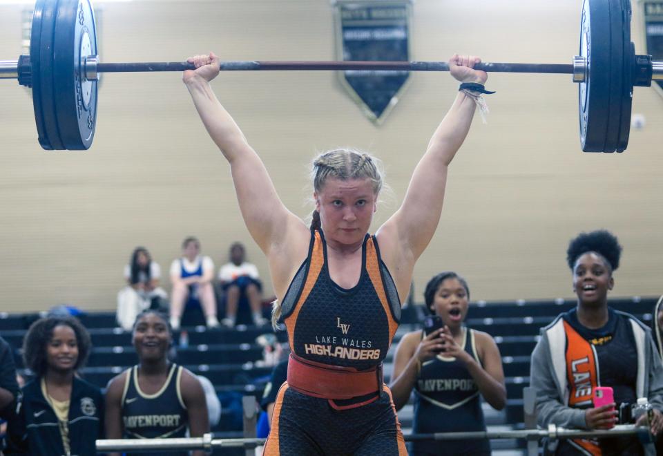 Lake Wales senior Kayden Arless completes a lift in the 154-pound weight class at the Class 2A, District 11 girls weightlifting meet at Davenport High School.