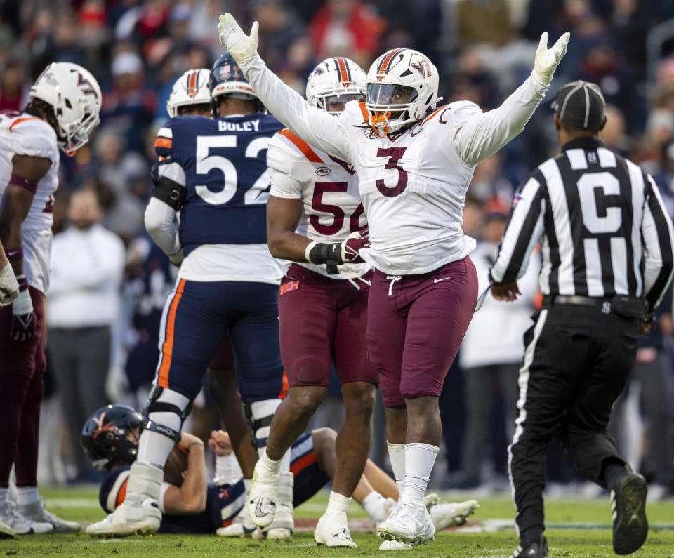 Virginia Tech defensive lineman Norell Pollard (3) celebrates after sacking Virginia quarterback Anthony Colandrea during the first half of an NCAA college football game Saturday, Nov. 25, 2023, in Charlottesville, Va. (AP Photo/Mike Caudill)