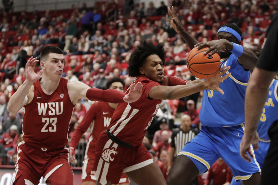 Washington State forwards Andrej Jakimovski (23) and Isaac Jones, center, chase down a rebound against UCLA forward Adem Bona, right, during the first half of an NCAA college basketball game, Saturday, March 2, 2024, in Pullman, Wash. (AP Photo/Young Kwak)
