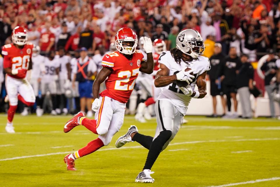 Las Vegas Raiders wide receiver Davante Adams (17) scores a touchdown against the Kansas City Chiefs during a 2022 game.