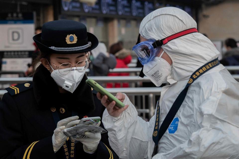 Security and subway staff wearing protective coverings to stop the virus spreading (AFP via Getty Images)