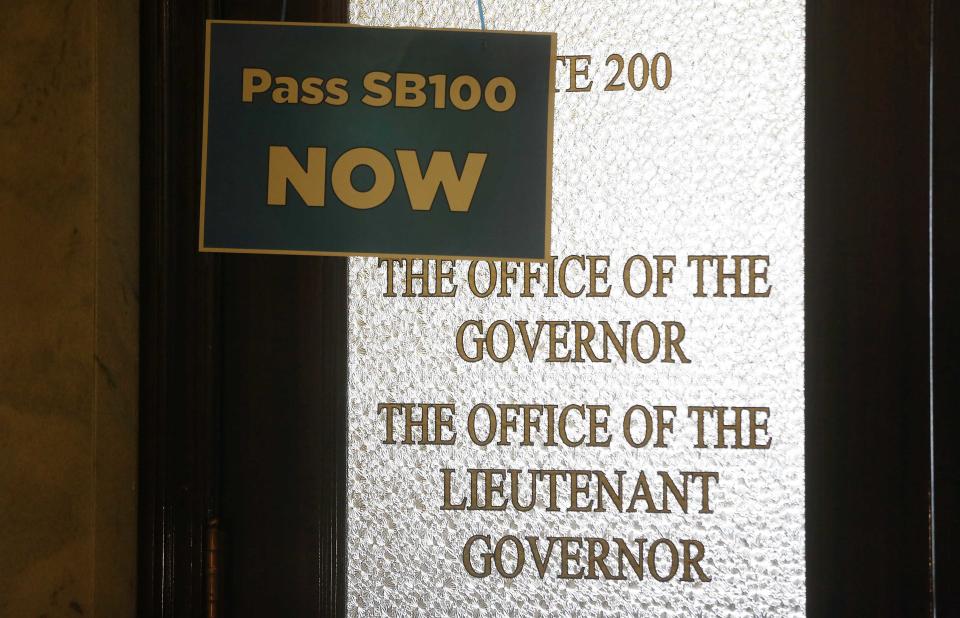 A sign hangs on the blocked door to the governor's office at the Utah State Capitol building in Salt Lake City February 10, 2014. LGBT rights activist are demanding the Legislature consider an anti-discrimination bill, Senate Bill 100, which the Senate has declined to do so. (REUTERS/Jim Urquhart)