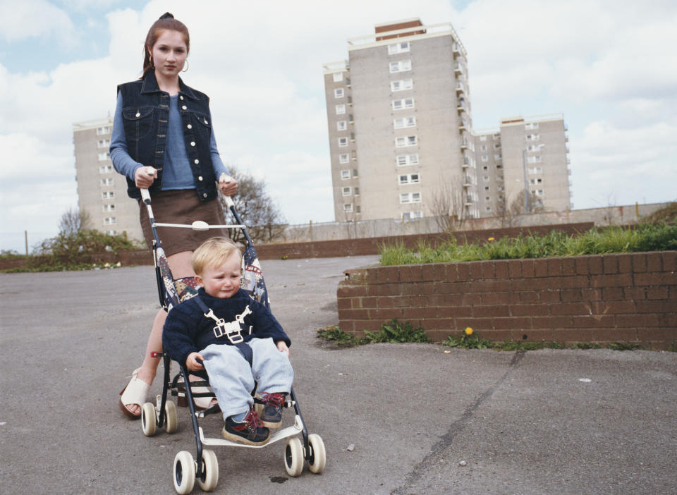 A young mother pushing her son in a stroller