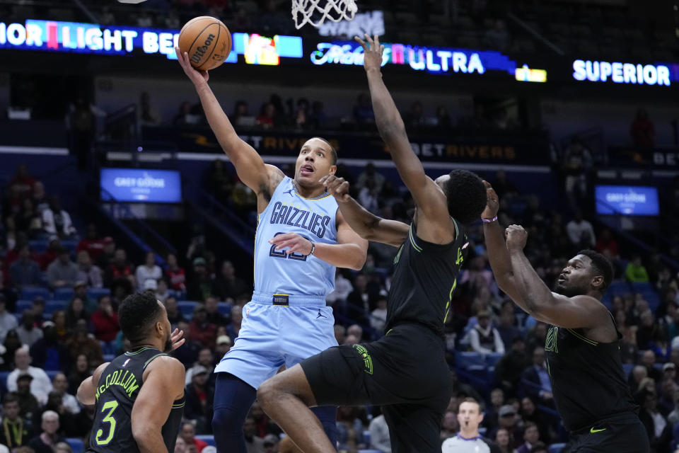 Memphis Grizzlies guard Desmond Bane goes to the basket against New Orleans Pelicans forward Herbert Jones in the first half of an NBA basketball game in New Orleans, Tuesday, Dec. 26, 2023. (AP Photo/Gerald Herbert)