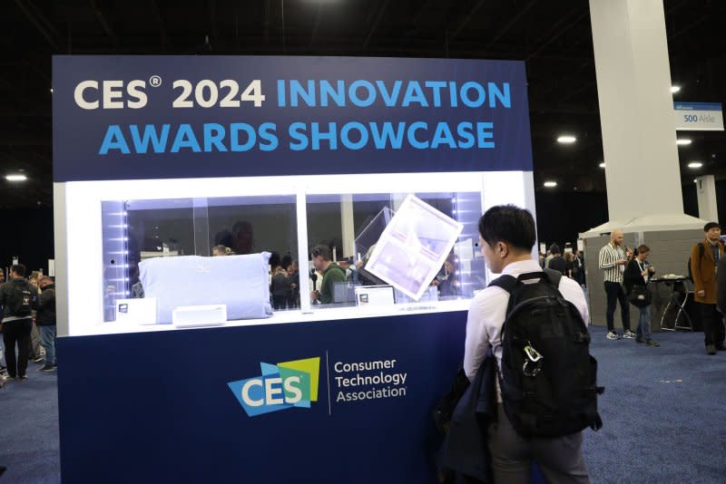 A CES 2024 attendee views products on display before the start of the 2024 International CES, at the Mandalay Bay Convention Center in Las Vegas on Sunday. Photo by James Atoa/UPI