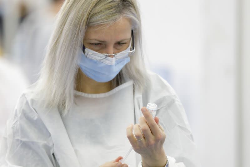 Medical staff prepares a dose of the COVID-19 vaccine at a vaccination center in Zagreb
