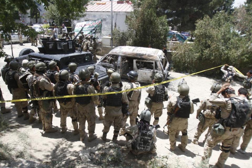 Afghan special forces are seen outside the Spozhmai hotel at Lake Qargha where security officials say Taliban insurgents have killed at least 17 people, most of them civilians, in an attack that began before midnight on Thursday, just north of Kabul, Afghanistan, Friday, June, 22, 2012. It was the latest in a string of attacks this week that suggest the insurgent group is pushing hard with its summer offensive rather than waiting for international forces to draw down. (AP Photo/Ahmad Jamshid)