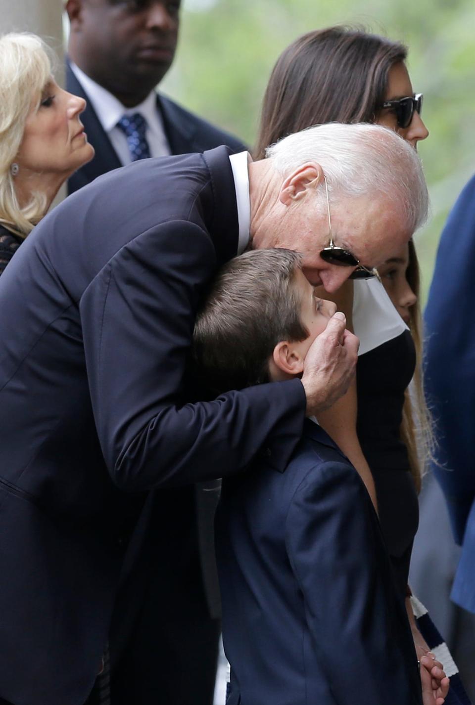 Joe Biden embraces his grandson Hunter before funeral services his son Beau on June 6, 2015, at St. Anthony of Padua Roman Catholic Church in Wilmington, Del. The eldest son of the vice president died of brain cancer at age 46.