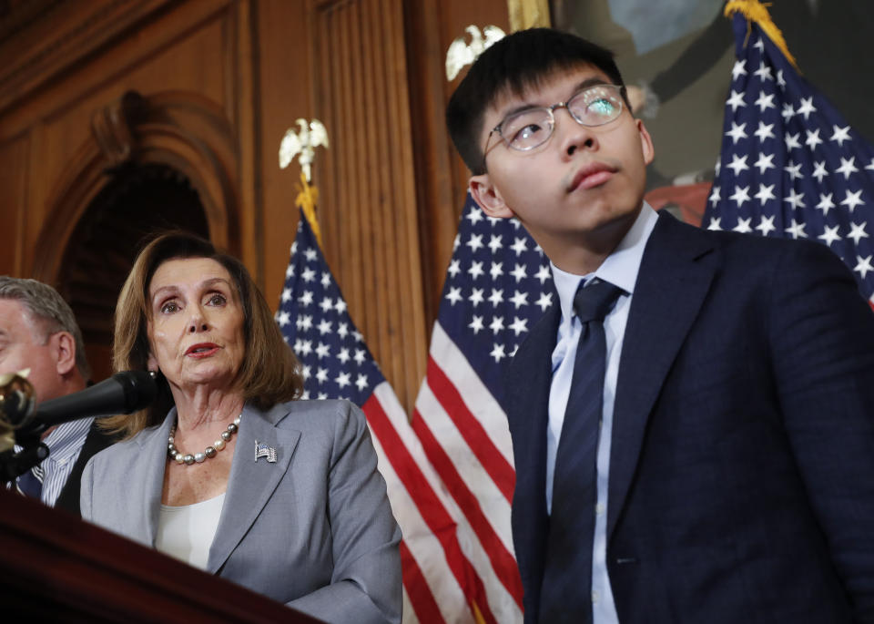 House Speaker Nancy Pelosi, left, with Hong Kong activist Joshua Wong and other members of Congress during a news conference on human right in Hong Kong on Capitol Hill in Washington, Wednesday, Sept. 18, 2019. (AP Photo/Pablo Martinez Monsivais)