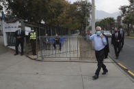 Chile's President Sebastian Pinera waves as he arrives to vote in the Constitutional Convention election to elect assembly members who will draft a new constitution, in Santiago, Chile, Saturday, May 15, 2021. The face of a new Chile begins taking shape this weekend as the South American country elects 155 people to draft a constitution to replace one that has governed it since being imposed during a military dictatorship. (AP Photo/Esteban Felix)