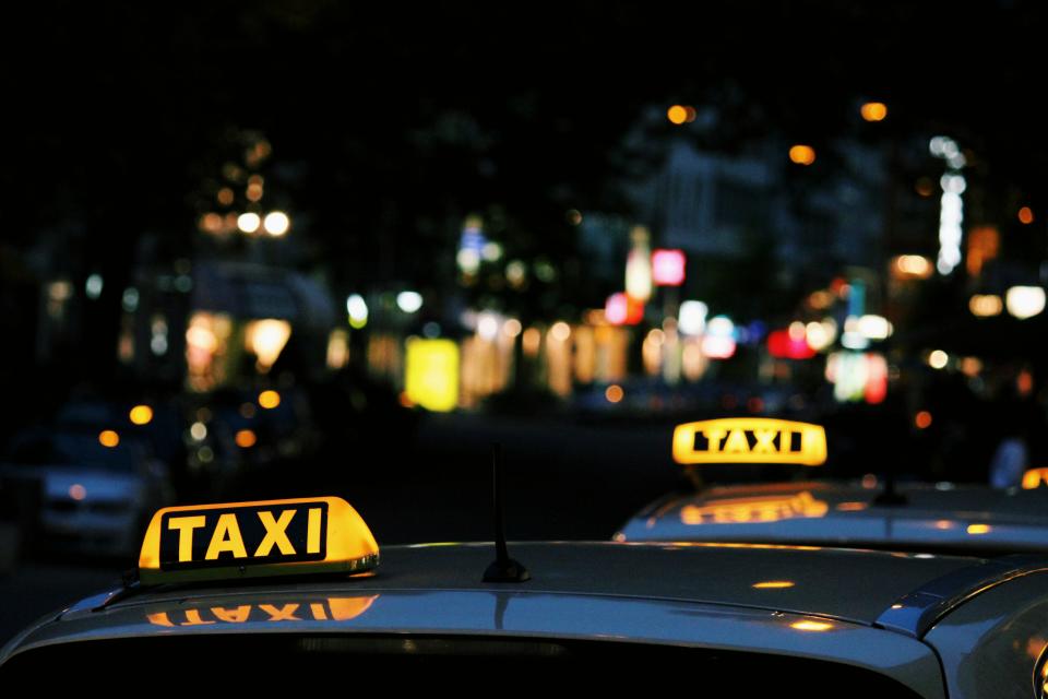 Photo of a couple taxis at night