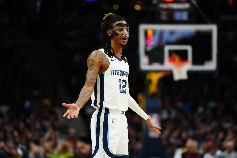 Memphis Grizzlies guard Ja Morant (12) reacts to a foul called in the second half against the Denver Nuggets at Ball Arena.