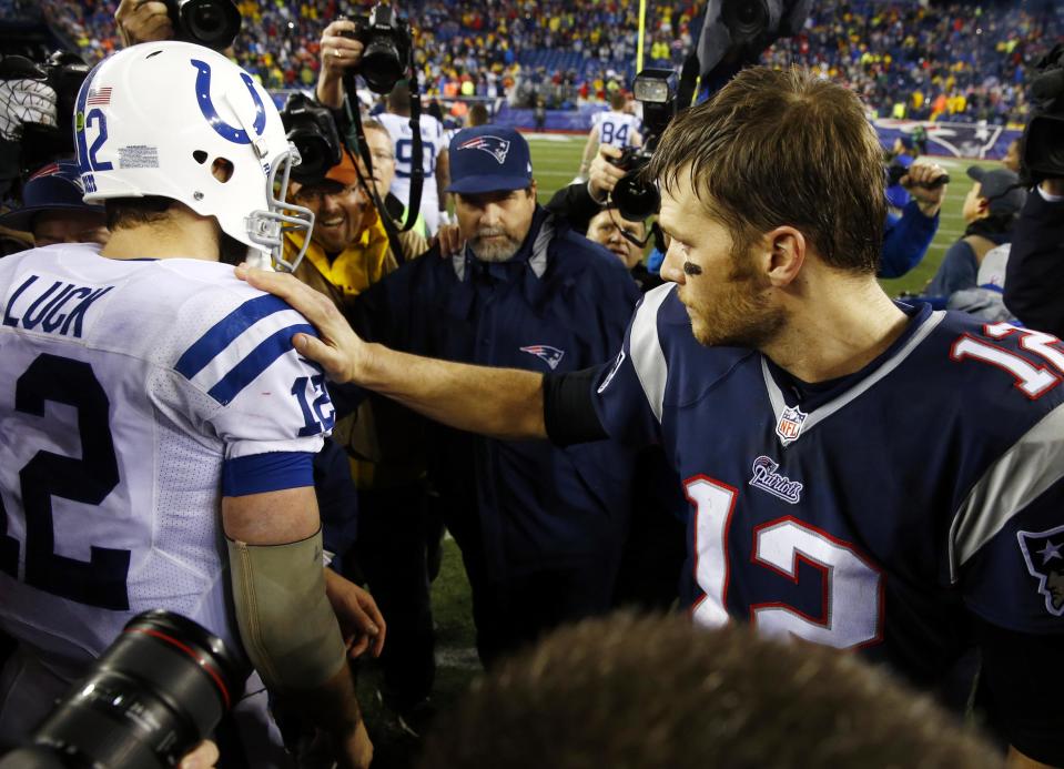 Jan 11, 2014; Foxborough, MA, USA; New England Patriots quarterback Tom Brady (12) and Indianapolis Colts quarterback Andrew Luck (12) meet the 2013 AFC divisional playoff football game at Gillette Stadium. The Patriots defeated the Indianapolis Colts 43-22. Mandatory Credit: David Butler II-USA TODAY Sports