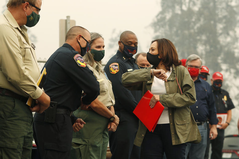 Democratic vice presidential candidate Sen. Kamala Harris, D-Calif., bumps elbows with first responders as she was briefed on the Creek Fire at Pine Ridge Elementary, Tuesday, Sept. 15, 2020 in Auberry, Calif. (AP Photo/Gary Kazanjian)