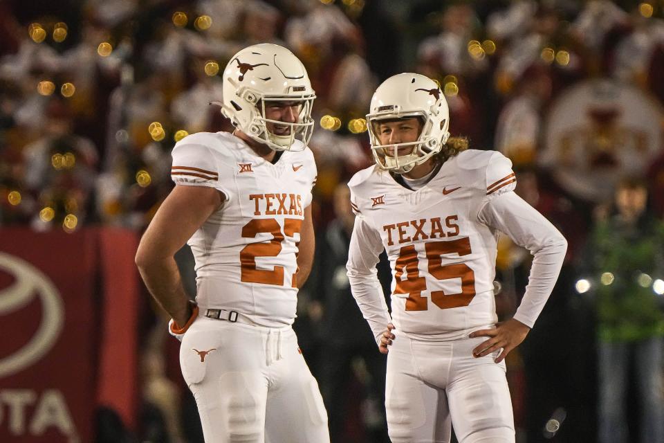 Texas punter and holder Ryan Sanborn, left, and place-kicker Bert Auburn talk before an extra-point attempt against Iowa State last November. Auburn is back this season for the Longhorns, but Sanborn isn't.