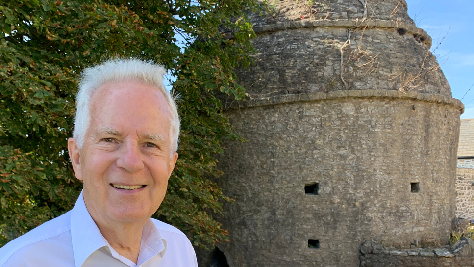 Dennis Clarke pictures outside the medieval dovecote