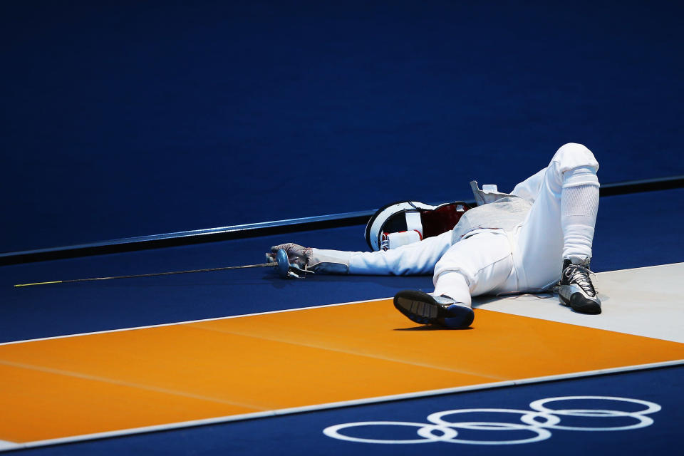 LONDON, ENGLAND - JULY 28: Carolin Golubytskyi of Germany lies on the ground after being struck in her Women's Foil Individual Fencing round of 16 match against Elisa Di Francisca of Italy on Day 1 of the London 2012 Olympic Games at ExCeL on July 28, 2012 in London, England. (Photo by Hannah Johnston/Getty Images)