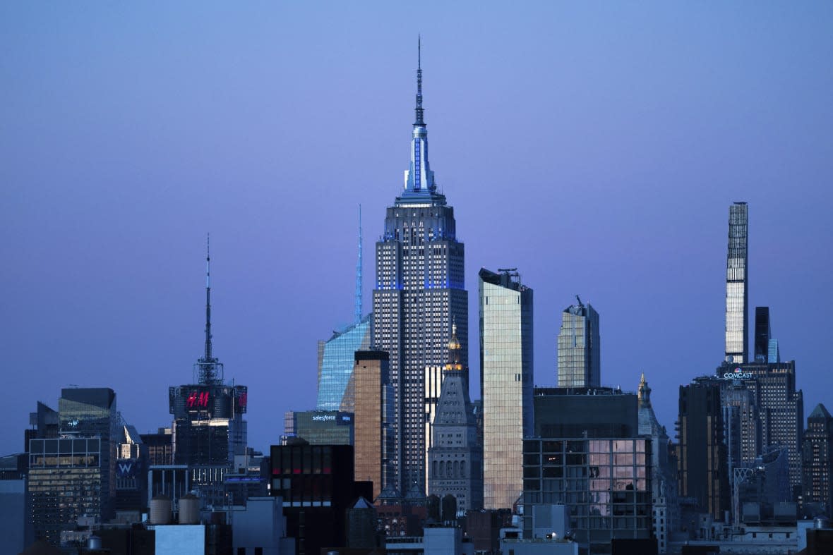 The Empire State Building glows blue during dusk, Monday, Nov. 14, 2022, in New York. (AP Photo/Julia Nikhinson, File)