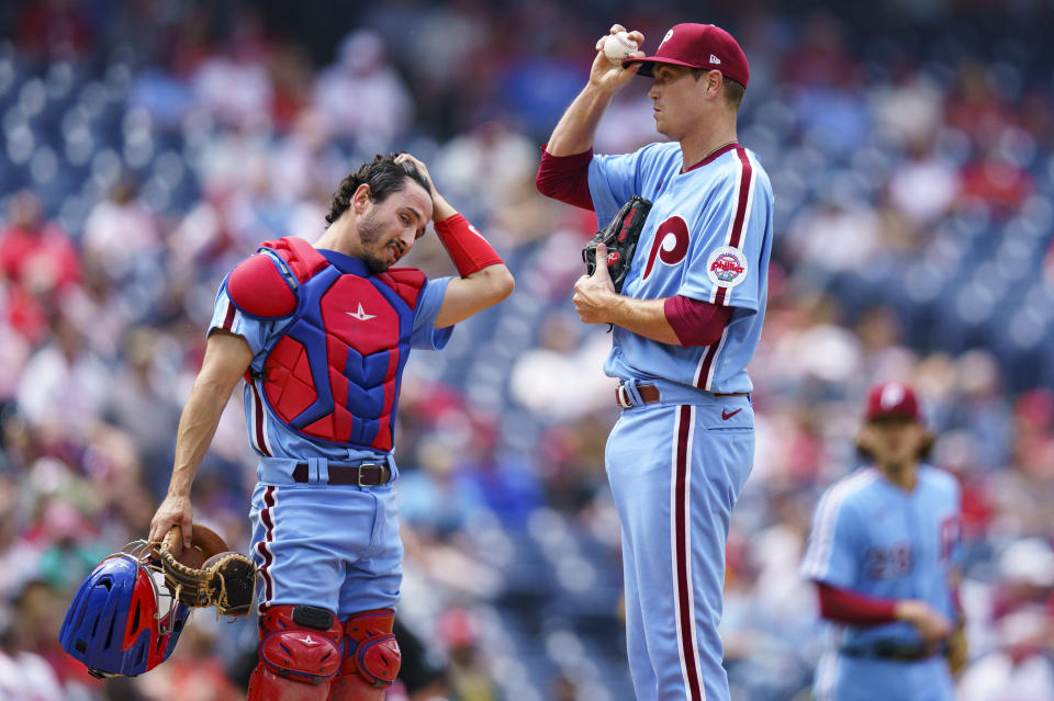 Philadelphia Phillies starting pitcher Kyle Gibson, right, looks on with catcher Garrett Stubbs, left, during the fourth inning of a baseball game against the San Diego Padres, Thursday, May 19, 2022, in Philadelphia. (AP Photo/Chris Szagola)