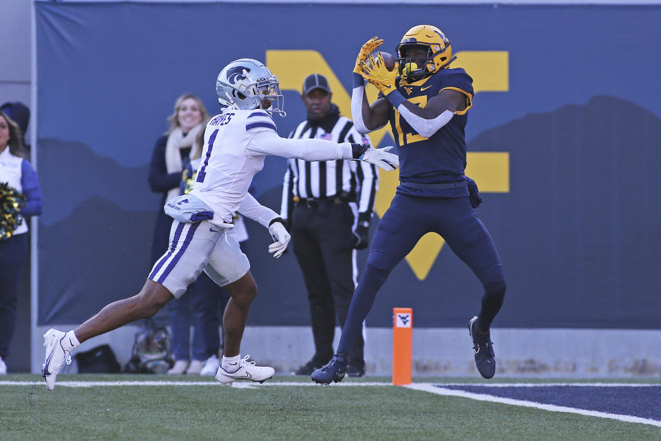 West Virginia wide receiver Sam James (13) catches a touchdown pass while defended by Kansas State safety Josh Hayes (1) during the first half of an NCAA college football game in Morgantown, W.Va., Saturday, Nov. 19, 2022. (AP Photo/Kathleen Batten)