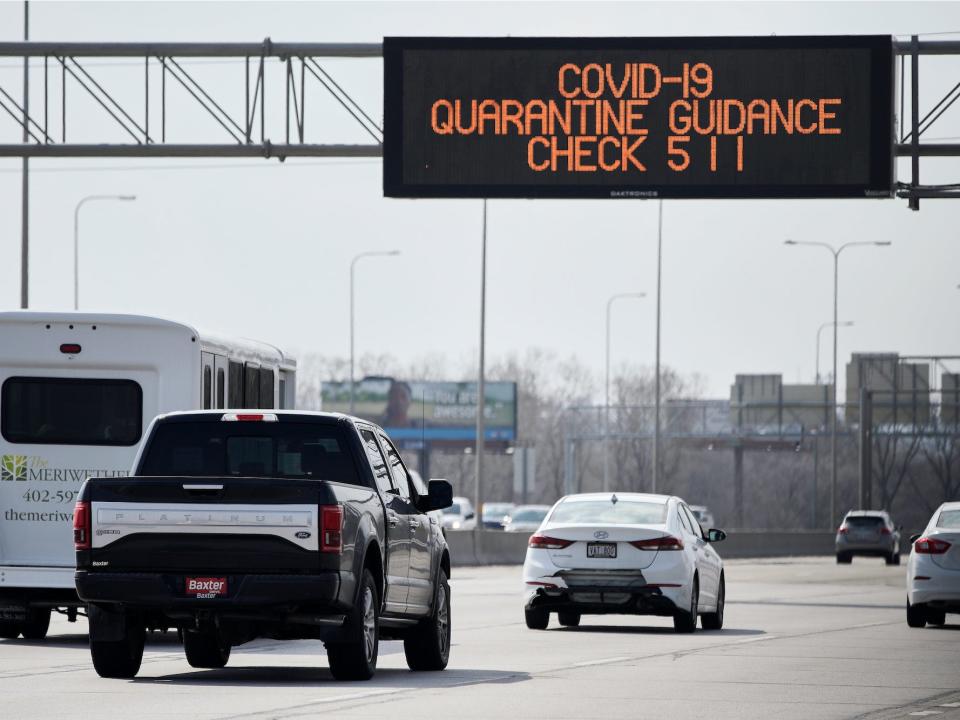A road sign over Interstate 80 in Omaha, Neb., directs motorists to contact 511 for Covid 19 quarantine guidance, Tuesday, March 31, 2020.