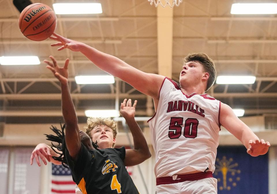 Danville's center Evan Lawrence (50) reaches to block the ball against Avon Orioles guard Rashod Bethley (4) on Saturday, Jan. 6, 2024, during the game at Danville Community High School in Danville.