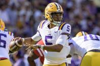LSU quarterback Jayden Daniels (5) looks to throw during the first half of an NCAA college football game against Mississippi in Baton Rouge, La., Saturday, Oct. 22, 2022. (AP Photo/Matthew Hinton)