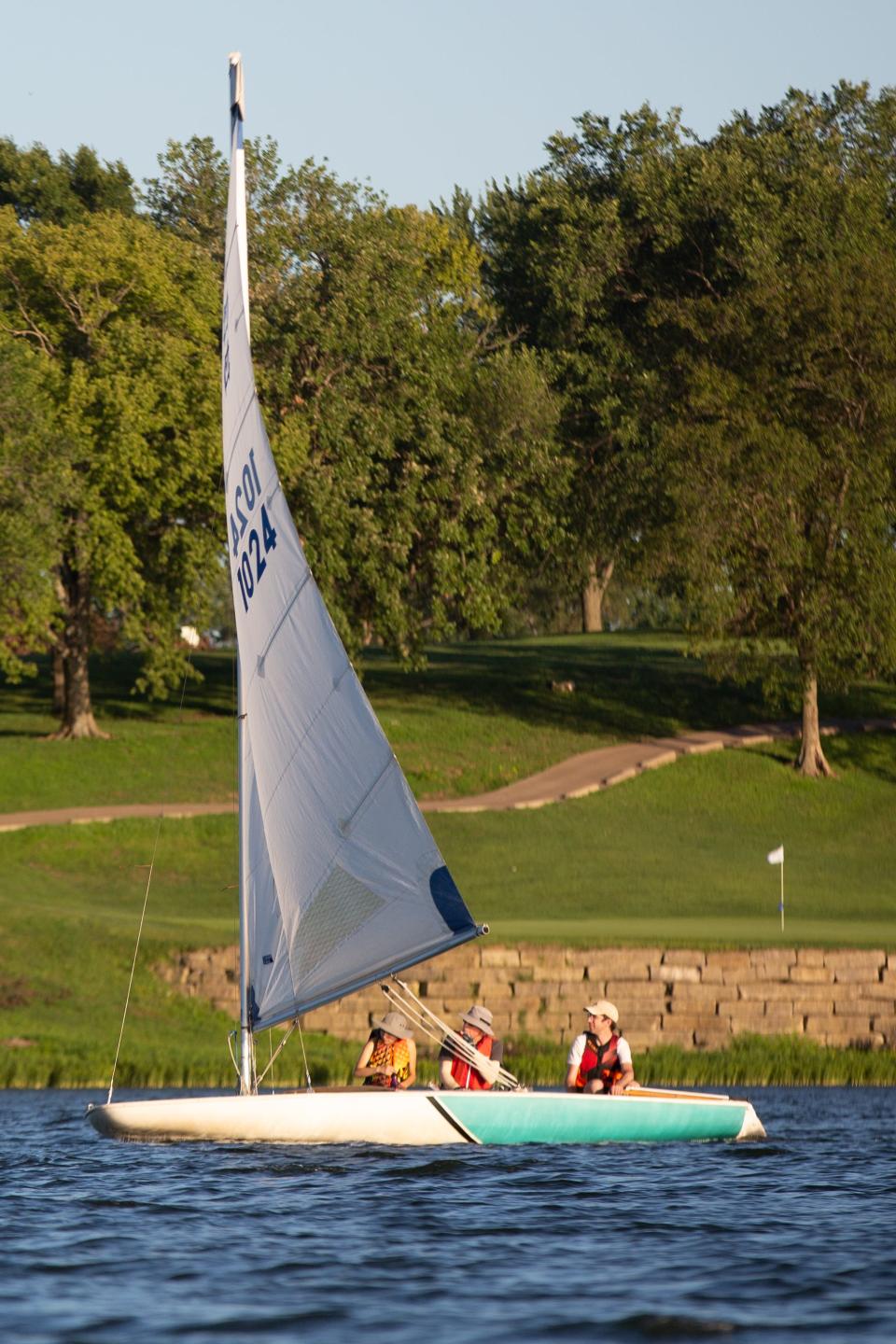 Shawnee County Yacht Club board member Mike Gorman, middle, sails alongside Zoe Bowlus, left, and Hartwin Peelaers in a fractional sloot vessel at Lake Shawnee recently. The two Lawrence residents have sailed before, as Bowlus previously taught sailing lessons for children in Maine.