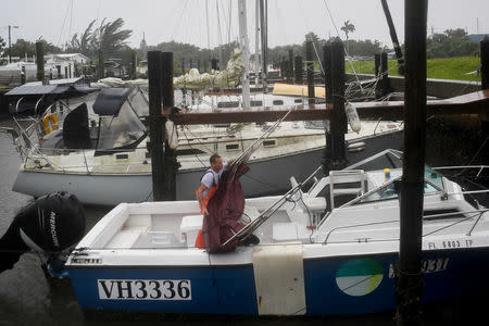 Local fisherman P.J. Pike secures, in tropical storm wind and rain, gear on his boat docked in Hurricane Harbor, as hurricane Irma approaches Fort Myers Beach, Florida, U.S., September 10, 2017. REUTERS/Bryan Woolston