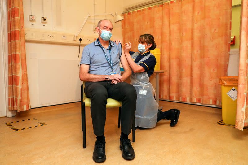 Professor Andrew Pollard receives the Oxford University/AstraZeneca COVID-19 vaccine at the Churchill Hospital in Oxford