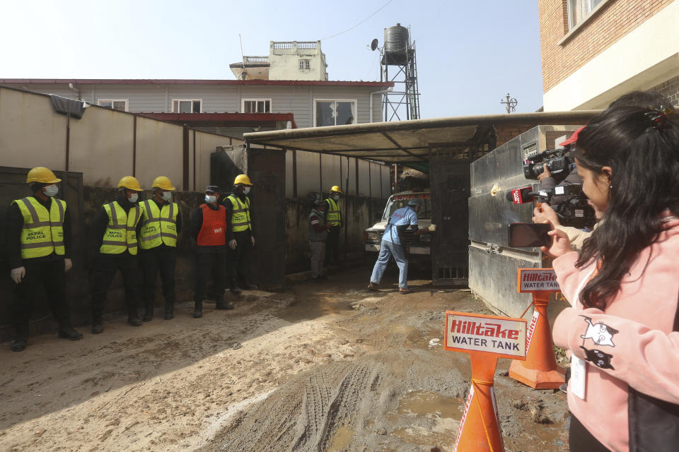 An ambulance carrying bodies of victims of a plane crash arrives at a hospital in Kathmandu, Nepal, Tuesday, Jan. 17, 2023. Nepalese authorities on Tuesday began returning to families the bodies of victims of a flight that crashed Sunday, and said they were sending the aircraft's data recorder to France for analysis as they try to determine what caused the country's deadliest plane accident in 30 years. (AP Photo/Bikram Rai)