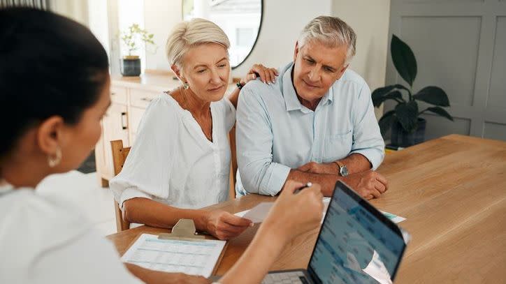 A financial advisor holds a consultation with prospective clients.