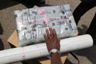 A Sri Lankan polling officer holds ballot papers and election material to dispatch to polling centers ahead of the parliamentary elections in Colombo, Sri Lanka, Tuesday, Aug. 4, 2020. Sri Lankans are voting in parliamentary elections Wednesday that are expected to strengthen President Gotabaya Rajapaksa's grip on power. Parts of the party are also calling for a two-thirds majority in Parliament so it can amend the constitution to restore presidential powers curbed by a 2015 constitutional change. (AP Photo/Eranga Jayawardena)