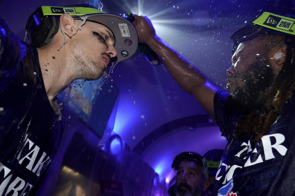 Toronto Blue Jays' Vladimir Guerrero Jr., right, celebrates with teammates in the locker room after clinching a berth in the AL wild card series following a baseball game against the Tampa Bay Rays in Toronto, Sunday, Oct. 1, 2023. (Frank Gunn/The Canadian Press via AP)