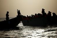 Miembros del barco de rescate de la ONG Proactiva Open Arms Uno ayudan a migrantes durante el rescate de una embarcación en el mar Mediterráneo central