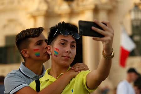 People take a selfie while celebrating after the Maltese parliament voted to legalise same-sex marriage on the Roman Catholic Mediterranean island, in Valletta, Malta July 12, 2017. REUTERS/Darrin Zammit Lupi