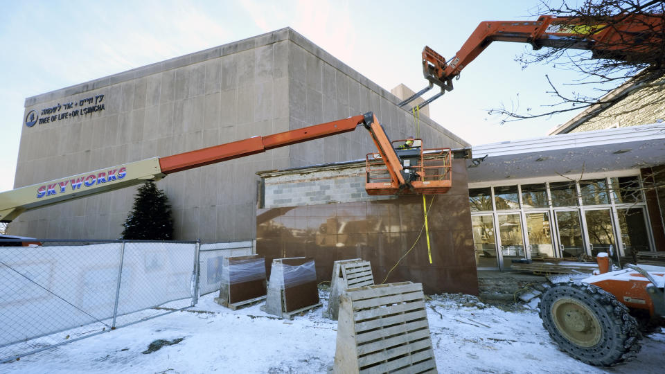 Workers begin demolition Wednesday, Jan. 17, 2023, at the Tree of Life building in Pittsburgh, the site of the deadliest antisemitic attack in U.S. history, as part of the effort to reimagine the building to honor the 11 people who were killed there in 2018. The demolition work began slowly, with crews picking away at the building's exterior. Most the building will be removed, although portions of the sanctuary walls will be preserved. (AP Photo/Gene J. Puskar)