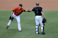 Baltimore Orioles non-roster invitee pitcher Thomas Eshelman, left, gives a fist bump to non-roster invitee catcher Bryan Holaday after working out during baseball training camp, Friday, July 3, 2020, in Baltimore. (AP Photo/Julio Cortez)