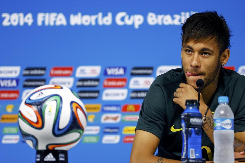 Brazil's Neymar listens to reporters' questions before his team's final practice in Sao Paulo, one day before the opening match of the soccer World Cup between Brazil and Croatia, June 11, 2014 REUTERS/Damir Sagolj (BRAZIL - Tags: SOCCER SPORT WORLD CUP)