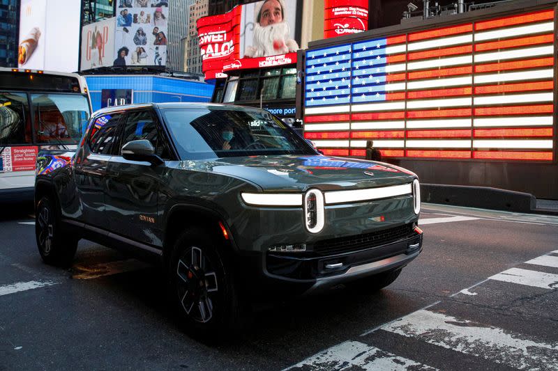 FILE PHOTO: A Rivian R1T pickup, the Amazon-backed electric vehicle (EV) maker, is driven through Times Square during the company’s IPO in New York