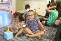 Brynn Schulte, 4, center, plays with her nanny's daughter Gracie Grubbs before getting an infusion of medication, which she must get every day for her genetic bleeding disorder, at home in Cincinnati, Aug. 3, 2023. She was diagnosed thanks to whole genome testing, which was recently shown to be nearly twice as good at finding genetic disorders in sick babies as more targeted tests. Her parents and doctors credit early diagnosis with saving her life. (AP Photo/Laura Ungar)