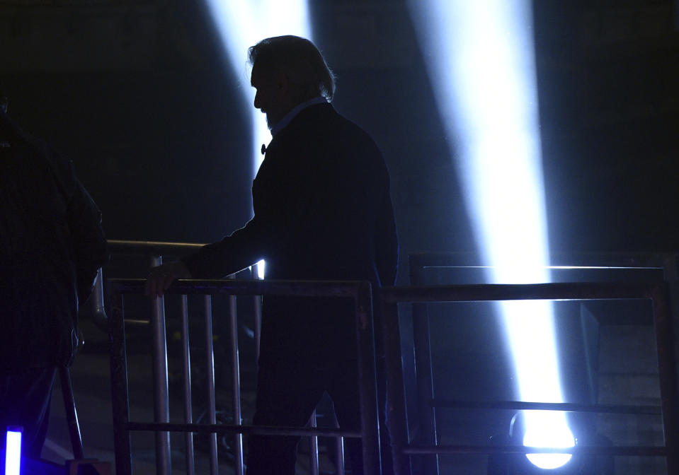 "Star Wars" film franchise cast member Harrison Ford is silhouetted as he exits the stage following a dedication ceremony for the new Star Wars: Galaxy's Edge attraction at Disneyland Park, Wednesday, May 29, 2019, in Anaheim, Calif. (Photo by Chris Pizzello/Invision/AP)
